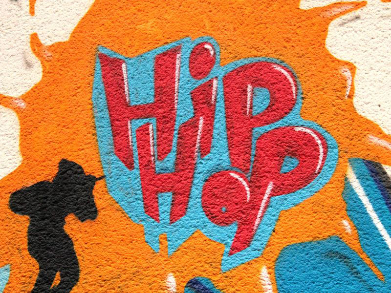 A close-up of a colorful mural features the words “HIP HOP.”