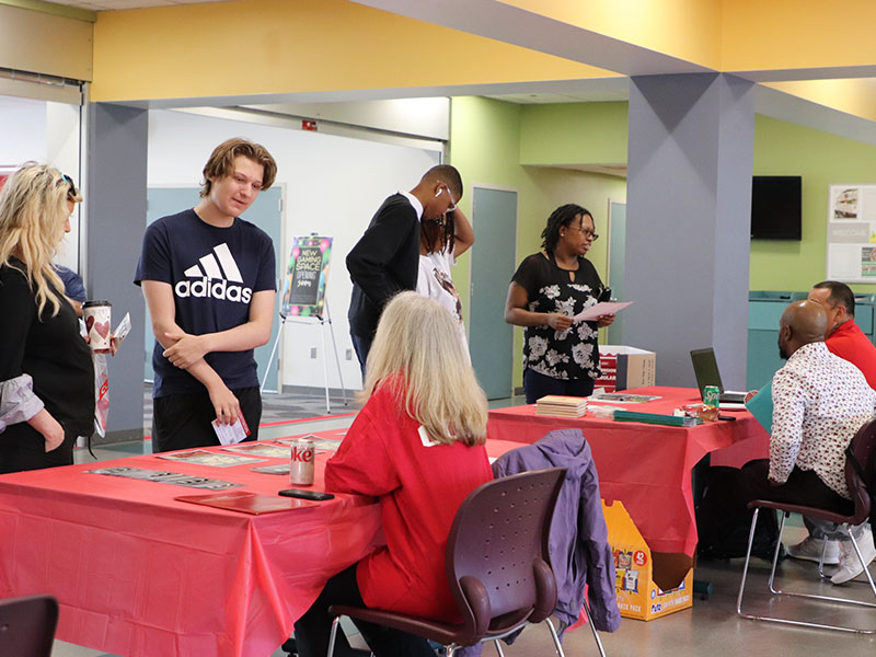 Prospective students and parents talk to CCAC staff at Open House event