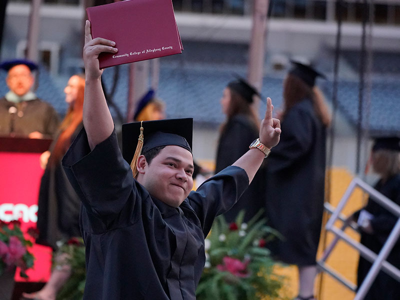 CCAC graduate celebrates during a commencement ceremony.