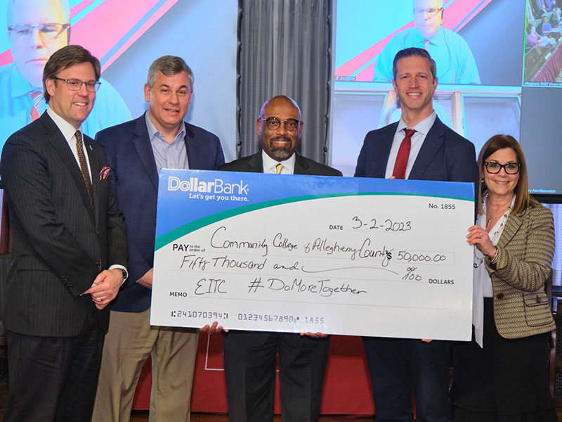 Representatives from Dollar Bank and CCAC exchange a large check for $50,000. Pictured left to right: Jamie Mc Mahon, CCAC Educational Foundation CEO; Kevin Kinross, Chair, CCAC Board of Trustees; Dr. Quintin Bullock, CCAC President; Jeff Evans, Dollar Bank Senior Vice President of Treasury Management; and Jackie Rizzo, Dollar Bank Vice President of Treasury Management Operations.