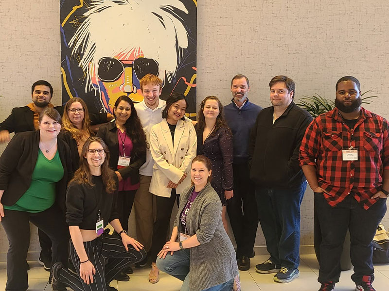 Pictured from left to right: Uday Sharma, Jessica Wheeler, Ahimsa Shakti, Professor Srujana Kanjula, Alexander Dowling, Vanessa Alabaso, Sara Perrett, Professor Stephen Wells, Professor Scott Mayberry, Jaquan Brockman. Front row: Hans Mach, Professor Ashleigh Fox.