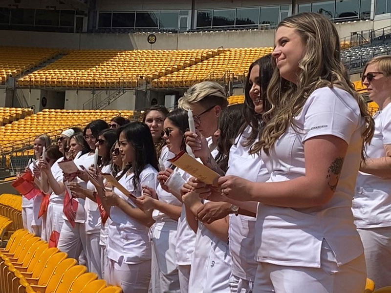 Nursing students wore the traditional white uniform and held candles during the Nurse Pinning ceremony on Thursday.