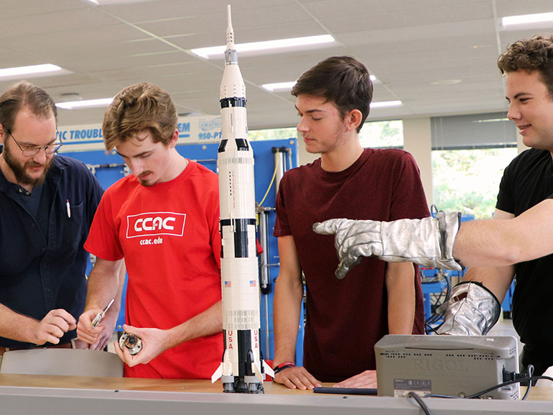A CCAC Spaceflight Student Team from the college's Mechatronics Apprenticeship program, Digital Electronics Class. Pictured from left to right: Peter Humphrey, Christopher Beaver, Brennan Yohe, and Geordan Lubay.