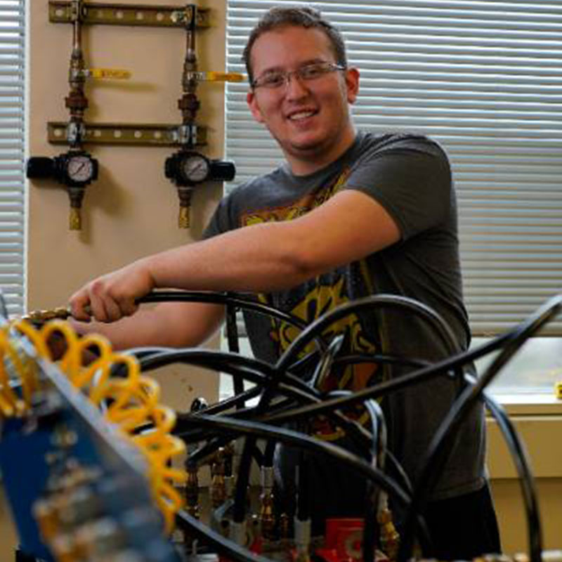 Jacob Graleski smiling in CCAC mechatronics lab