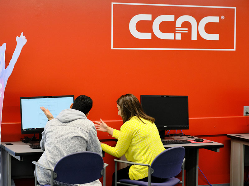 Students work at a computer on a CCAC campus.