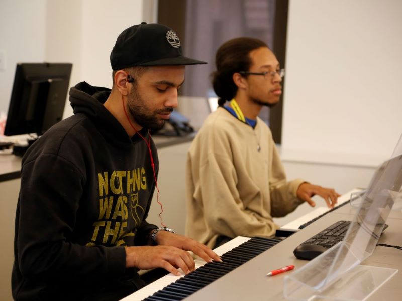 CCAC students experiment with electronic keyboards in the classroom.